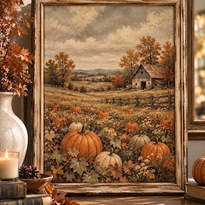 May include: A framed landscape painting depicting a rural autumn scene with a pumpkin patch in the foreground, a wooden fence, and a rustic barn in the distance. The artwork features orange and white pumpkins nestled among fallen leaves and foliage.