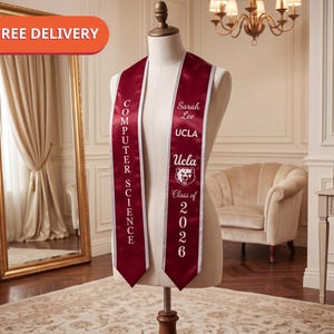 May include: A maroon graduation stole with white trim featuring the text COMPUTER SCIENCE on one side and Sarah Lee, UCLA, a bear mascot graphic, and Class of 2026 on the other side, displayed on a mannequin torso.