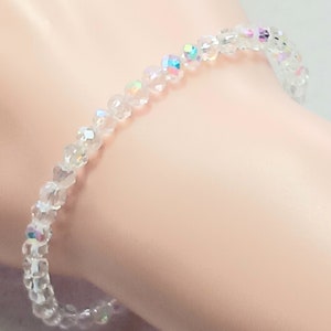 May include: A clear crystal bracelet with iridescent beads.