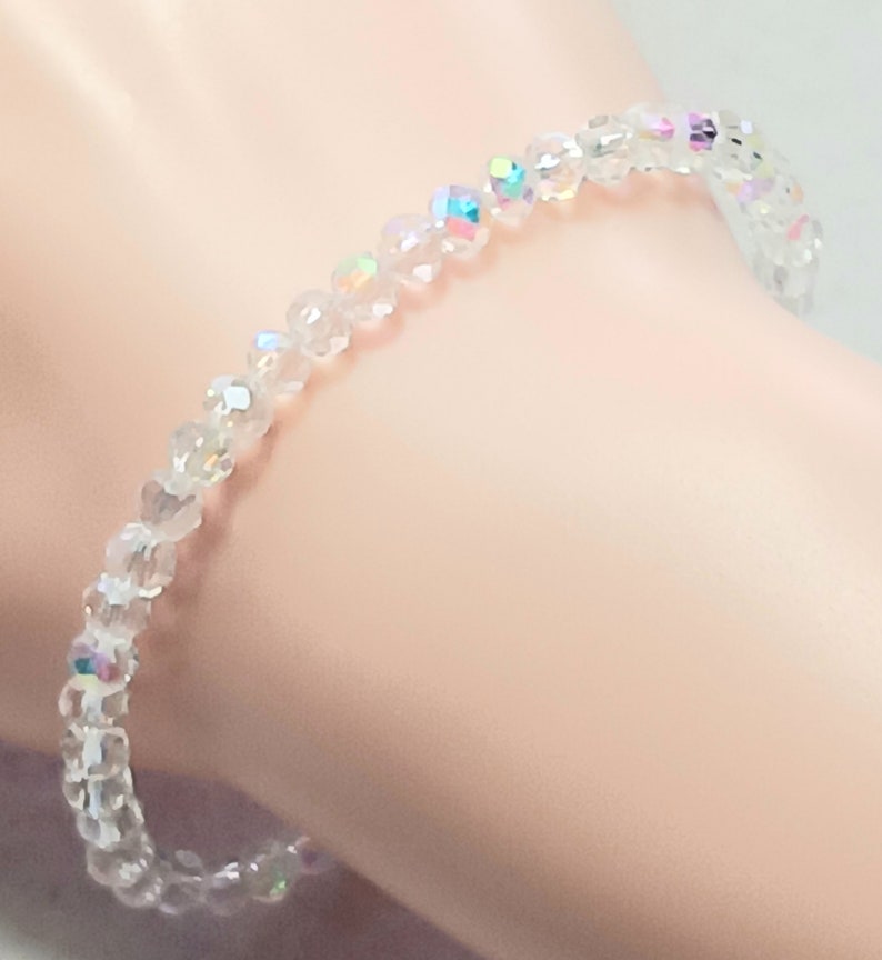 May include: A clear crystal bracelet with iridescent beads.