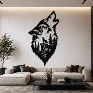 May include: Black metal wall art depicting a howling wolf with a forest and moon scene inside its silhouette. The artwork is mounted on a white wall above a beige sectional sofa and a black marble coffee table.