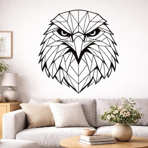 May include: A black and white geometric eagle head wall art. The eagle's head is composed of angular shapes, creating a modern, artistic design. This decorative piece is suitable for living rooms, bedrooms, or offices. The artwork is mounted on a white wall above a sofa.