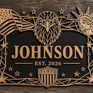Könnte beinhalten: Holzschild mit schwarzem Hintergrund und einem lasergeschnittenen Design mit einer amerikanischen Flagge, einem Adler, der Freiheitsstatue, Sternen und dem Namen "JOHNSON" mit "EST. 2026". Das Schild hat ein patriotisches Thema.