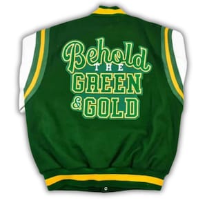 May include: Green and white varsity jacket with the text "Behold the Green & Gold" in a script font. The jacket has yellow trim on the sleeves and collar. The back of the jacket is green, with white sleeves.