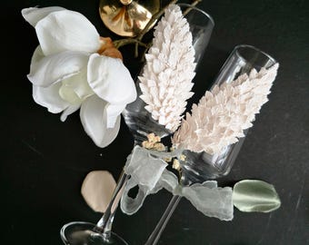 Elegant handmade wedding champagne flutes with sculpted polymer clay wings, created as a luxury keepsake for wedding toasts, bridal gifting,