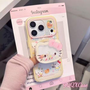 May include: A clear phone case with a Hello Kitty theme. The case has a pink and yellow design with Hello Kitty characters and a pop-up grip. The Instagram-themed background is visible.