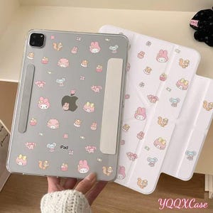 May include: A white ceramic mug with a black handle and the text "But First, Coffee" in a black, handwritten-style font. The mug is on a white surface.