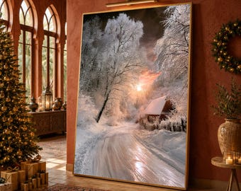 May include: A large rectangular wall art print featuring a winter landscape with snow-covered trees, a winding path, and a small cabin illuminated by a soft sunset glow. The artwork is framed in gold and mounted with an overhead picture light.