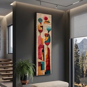 Könnte beinhalten: Ein rechteckiges Wandkunstwerk mit schwarzem Rahmen. Das Kunstwerk zeigt ein abstraktes Design mit Figuren in Rot, Rosa, Blau und Gelb. Der Hintergrund ist eine neutrale beige Farbe. Die Kunst hängt an einer dunkelgrauen Wand.