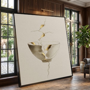 May include: A large square framed wall art piece featuring a minimalist illustration of a broken ceramic bowl on a textured off-white background. The cracks in the bowl are highlighted with metallic gold paint, extending upward and downward.