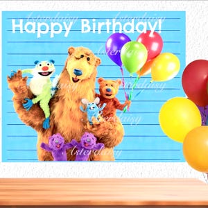 May include: A birthday poster with a large brown bear and several cartoon characters, holding colourful balloons. The words "Happy Birthday!" are written across the top in white. The background is light blue with vertical lines.