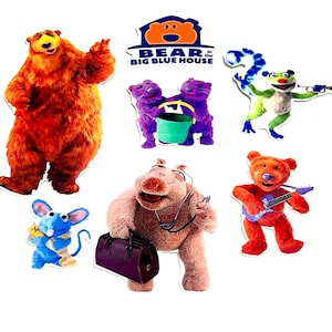 May include: A selection of colourful character cutouts from the children's television show, "Bear in the Big Blue House." The characters include a large orange bear, purple cats, a green frog, a red bear playing a guitar, a blue mouse, and a pink hippo.