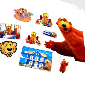 May include: A selection of colourful Bear in the Big Blue House themed stickers and cutouts. The images include the main character, Bear, and other characters, along with a blue house and a "Happy Birthday!" banner.