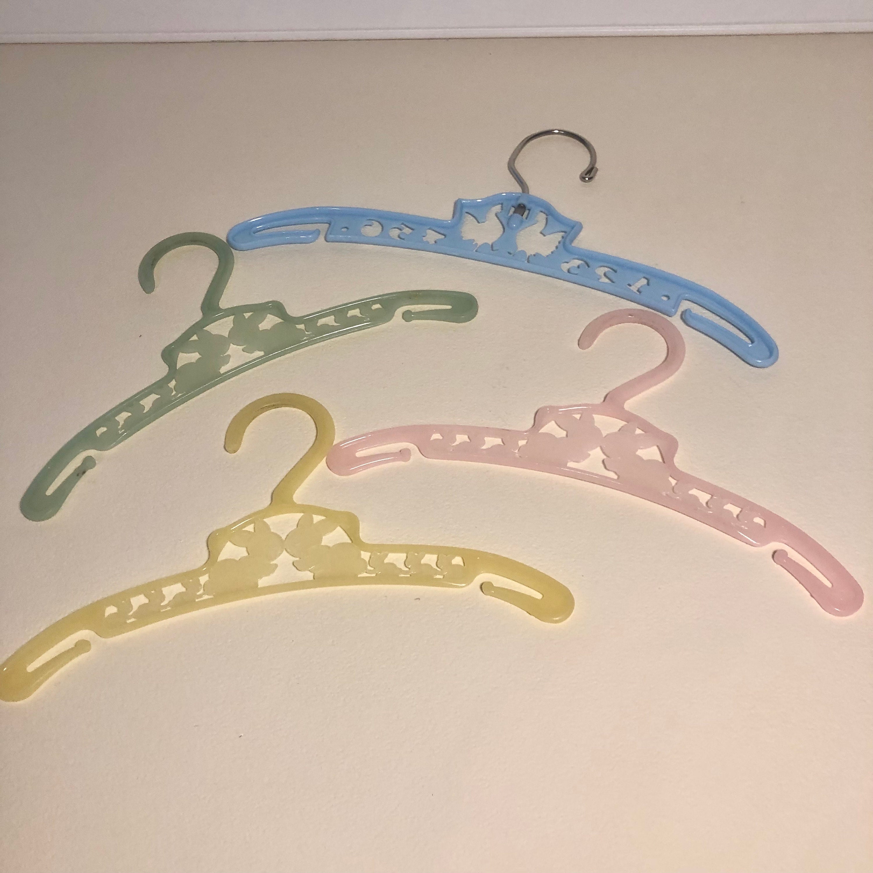 Four Vintage Plastic Baby Hangers 