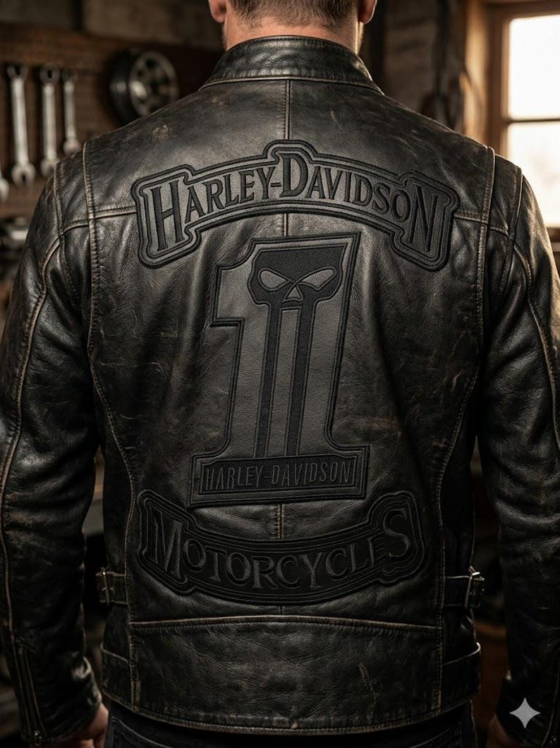 May include: Black leather motorcycle jacket with Harley-Davidson logo and number 1 skull graphic on the back. The jacket has a distressed finish and a classic biker style, with a zip-up front and multiple pockets.