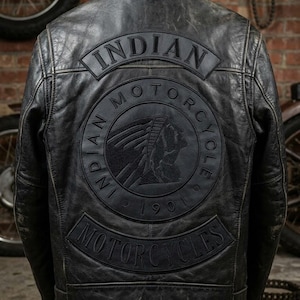 Könnte beinhalten: Schwarze Motorradjacke aus Leder mit dem geprägten "Indian Motorcycle" Logo auf dem Rücken. Die Jacke hat ein klassisches Design mit Kragen und Vordertaschen. Das Used-Finish verleiht ihr einen Vintage-Look.