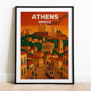 May include: Framed art print of Athens, Greece, featuring a stylized cityscape with the Parthenon and a red tram. The print has a warm color palette of orange, yellow, and green, with the text "ATHENS GREECE" at the top.