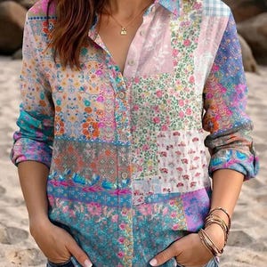 May include: A long-sleeve button-down shirt featuring a multi-colored patchwork design with various floral and geometric patterns in shades of pink, blue, orange, and white, finished with a classic collar and a front button placket.