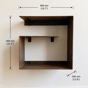 May include: A rustic, brown metal wall shelf with a unique, angular design. The shelf is 400 mm (15.7 inches) high and wide, with a depth of 300 mm (11.8 inches). The text "Right version" is visible.