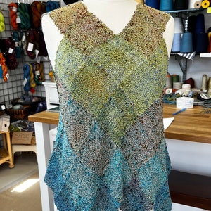 May include: A sleeveless, crocheted top with a V-neck and a diamond pattern in shades of brown, green, blue, and teal.