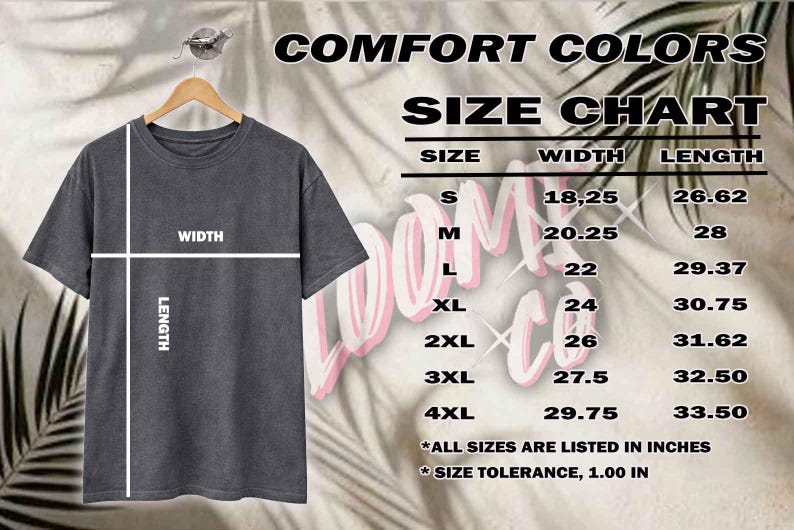 May include: A gray t-shirt hangs on a wooden hanger, with a size chart displayed to the right. The chart lists sizes S to 4XL, with width and length measurements in inches. The text "COMFORT COLORS" is at the top.