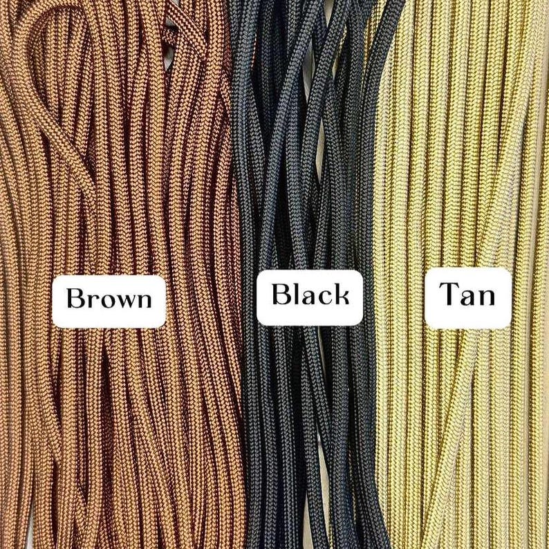 May include: Close-up of three bundles of paracord in brown, black, and tan. Each bundle is labeled with its respective color in a white rectangular box. The paracord is tightly woven and appears durable, suitable for various crafting and outdoor projects.