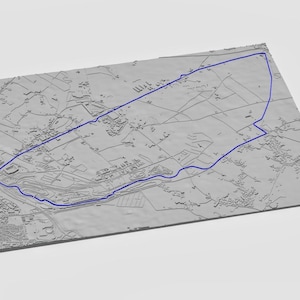 May include: A gray, three-dimensional topographical map with a blue outline. The map depicts a detailed landscape with buildings, roads, and fields. The blue line traces a specific route or area of interest.