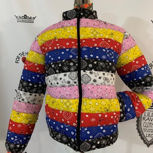 May include: A colorful puffer jacket with a bandana print. The jacket has a zipper closure and is made of a quilted fabric. The jacket is available in a variety of colors, including red, blue, yellow, and black.