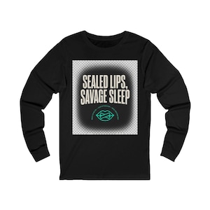 May include: A black long-sleeve shirt featuring a central graphic with the text "SEALED LIPS, SAVAGE SLEEP" in a bold, light-colored font. Below the text is a teal-colored outline of lips with a horizontal line across them, set against a dark background.