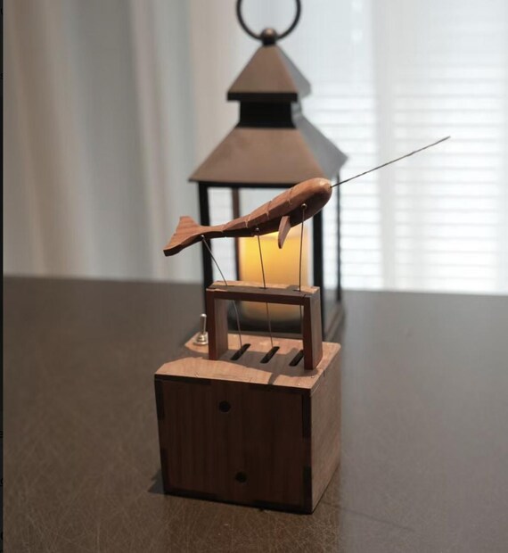 A hand-carved wooden shrimp that actually moves — an automaton in the classic folk-art tradition, except it's a crustacean, which makes it perfect.