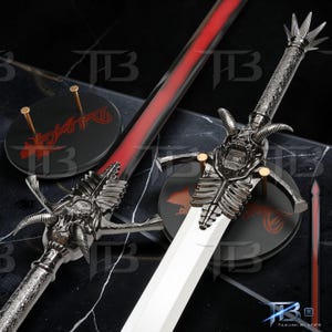 May include: A fantasy sword with a silver handle and a white blade. The sword has a red spine and a decorative guard with a skull design. The sword rests on a black stand with red text. The overall design is intricate.