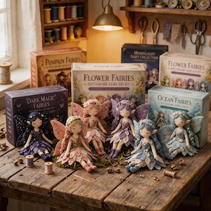 May include: Five handcrafted fairy dolls with fabric wings and floral-inspired outfits displayed in front of their respective DIY kit boxes labeled Flower Fairies, Pumpkin Fairies, Moonlight Fairy Collection, Dark Magic Fairies, and Ocean Fairies.