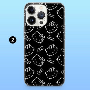 May include: Black phone case with a white outline pattern of Hello Kitty faces and bows. The case has a clear border and a camera cutout. The number "2" is visible in the upper left corner.