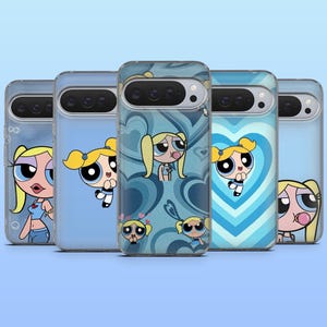 May include: Five phone cases featuring the cartoon character Bubbles from The Powerpuff Girls. The cases have a clear, protective design with various blue backgrounds and Bubbles illustrations. The cases are a mix of light and dark blue hues.