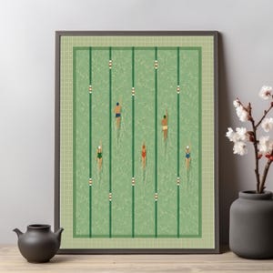 May include: A framed art print depicting an overhead view of a swimming pool with five swimmers in separate lanes. The pool water is a textured light green with dark green lane markers and white buoys. The swimmers wear various colored swimsuits.