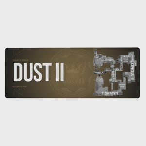 May include: A rectangular mouse mat featuring the "Dust II" map from Counter-Strike. The map is in shades of grey and white, with labelled areas. The words "DUST II" are prominently displayed in large white letters. The background is a gradient of brown and black.