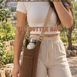 May include: A brown canvas bottle bag with a long, adjustable beige strap and a small front pocket. The bag holds a white metal water bottle with a silver cap. The text "PATTERN & THREAD STUDIO" and "THE BOTTLE BAG" is visible in the image.