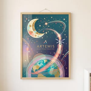 May include: A framed art print featuring a colorful illustration of the Artemis Deep Space Mission. The artwork depicts a crescent moon, Earth, a rocket, and swirling lines against a dark blue background. The print is in a light wood frame.