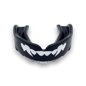 May include: A black mouthguard featuring a white graphic print of sharp, pointed teeth across the front. The protective dental device has a contoured U-shape design with a smooth exterior surface and a clear, moulded inner channel for teeth.