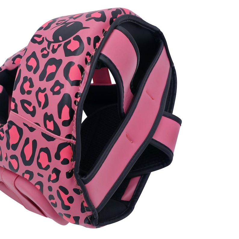 May include: Pink and black leopard print boxing headgear. The headgear has a pink exterior with black leopard spots. The straps and trim are a solid pink color. The interior is black.