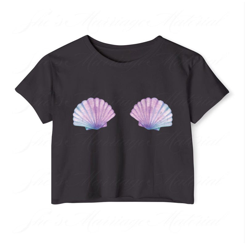 May include: Black crop top with two seashell designs in purple, blue, and white. The shells are placed symmetrically on the front. The top has short sleeves and a round neck.