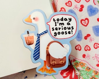 May include: A whimsical sticker featuring a white goose with an orange beak and feet, wearing a blue striped tie and carrying a brown briefcase and a bubble tea. Text reads "today I'm a serious goose!"