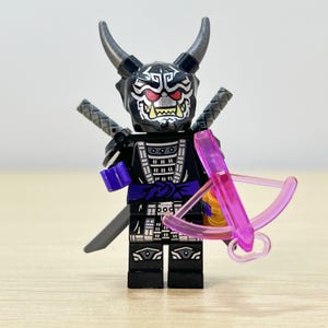 May include: A white ceramic mug with a black handle and the text "But First, Coffee" in a black, bold font. The mug is on a white surface.