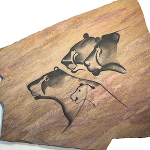 Chauvet Lions cave art painting on hanging stone