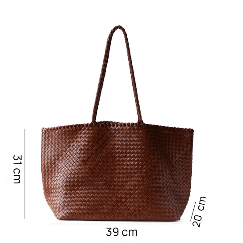 May include: A brown woven tote bag with a braided handle. The bag is 15.3 inches wide, 12.2 inches tall, and 7.9 inches deep. The bag has a rectangular shape and is made of a woven material.