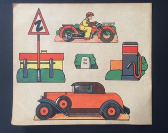 May include: A vintage paper craft set featuring a red car, a motorcycle with a rider, a gas station, a road sign with a 'Z' on it, and a sign that says '50 Km'.