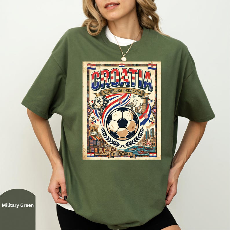 A woman wearing a green t-shirt with a graphic design featuring a soccer ball, a flag, and a cityscape.