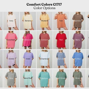 The image is a collage of 24 different color options for t-shirts, including white, ivory, banana, mustard, yam, espresso, pepper, watermelon, crunchberry, helioplex, crison, red, berry, black, and blue.