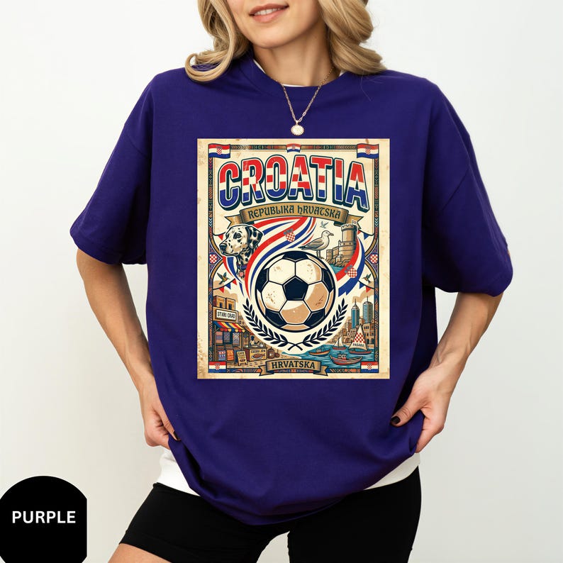 A woman wearing a purple t-shirt with a graphic design featuring a soccer ball, a flag, and various text elements related to Croatia.