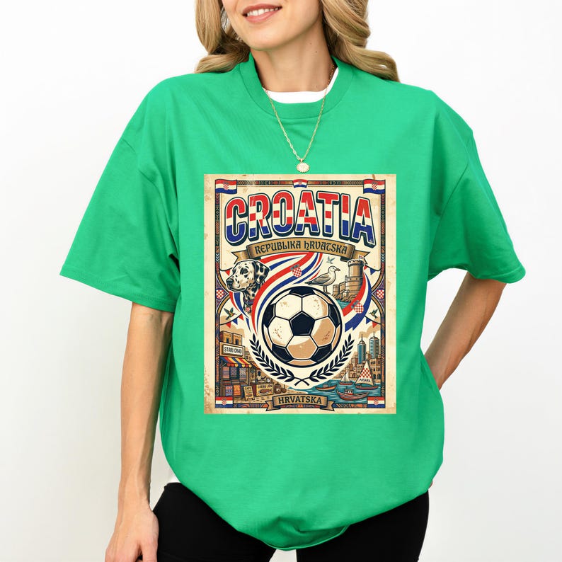 A woman wearing a green t-shirt with a graphic design featuring a soccer ball, a flag, and various elements associated with the country of Croatia.
